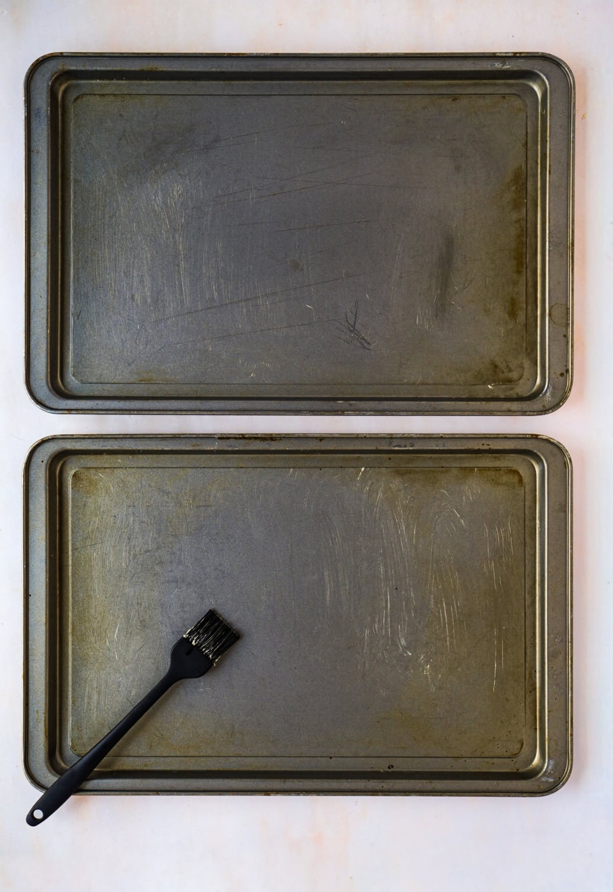 Baking trays being lightly greased before making Scottish Shortbread.
