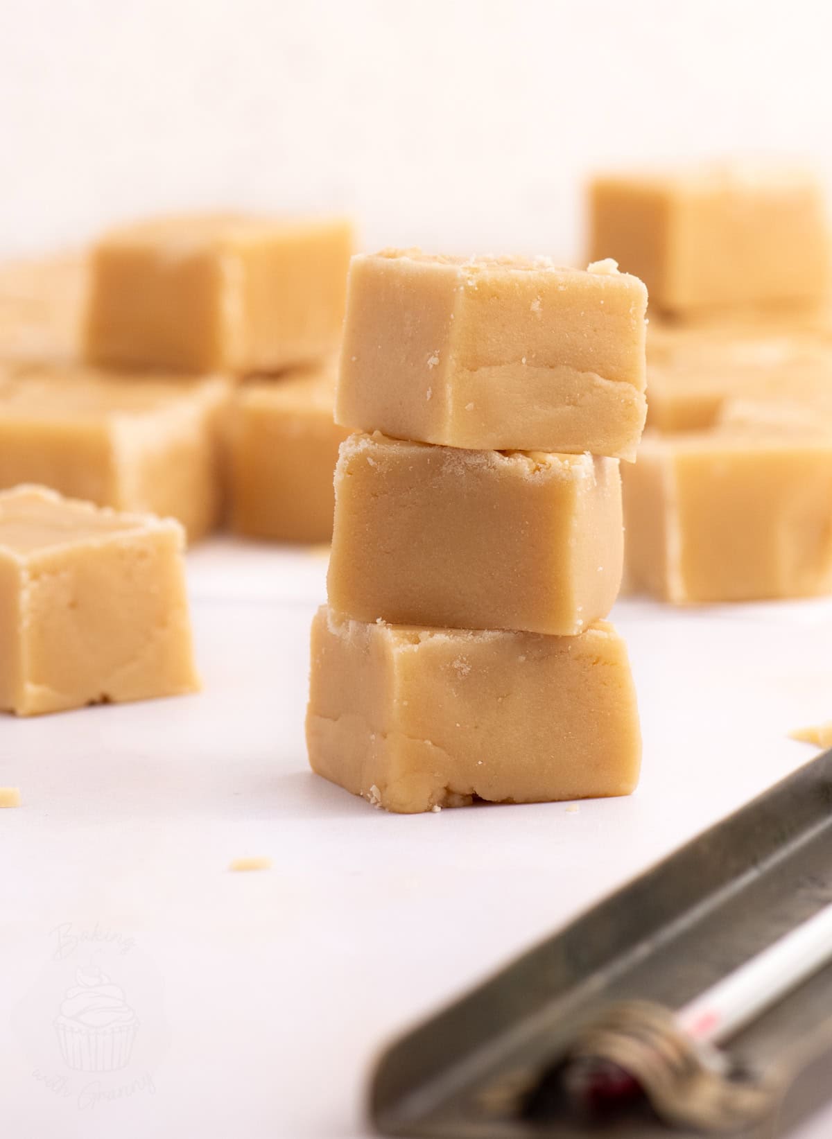 Stacked pieces of traditional Scottish tablet with a crumbly texture, part of a homemade recipe.