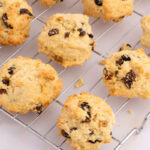 Freshly baked Rock Buns, packed with dried fruit, cooling on a wire rack.