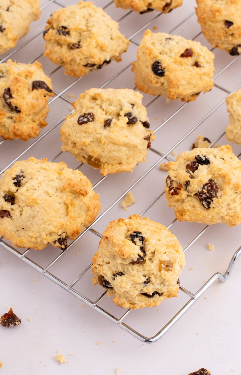 Freshly baked Rock Buns, packed with dried fruit, cooling on a wire rack.