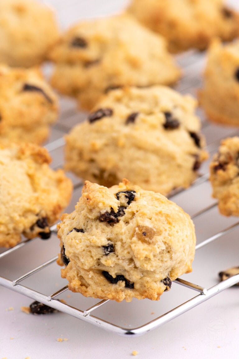 Close-up of golden Rock Bun with raisins, sultanas, currants and mixed fruit, on a cooling rack.