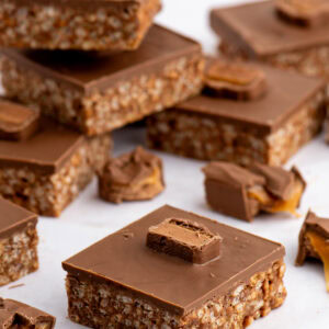 Homemade Mars Bar Slice with a chocolate rice crispy base, topped with smooth milk chocolate and pieces of Mars Bar.