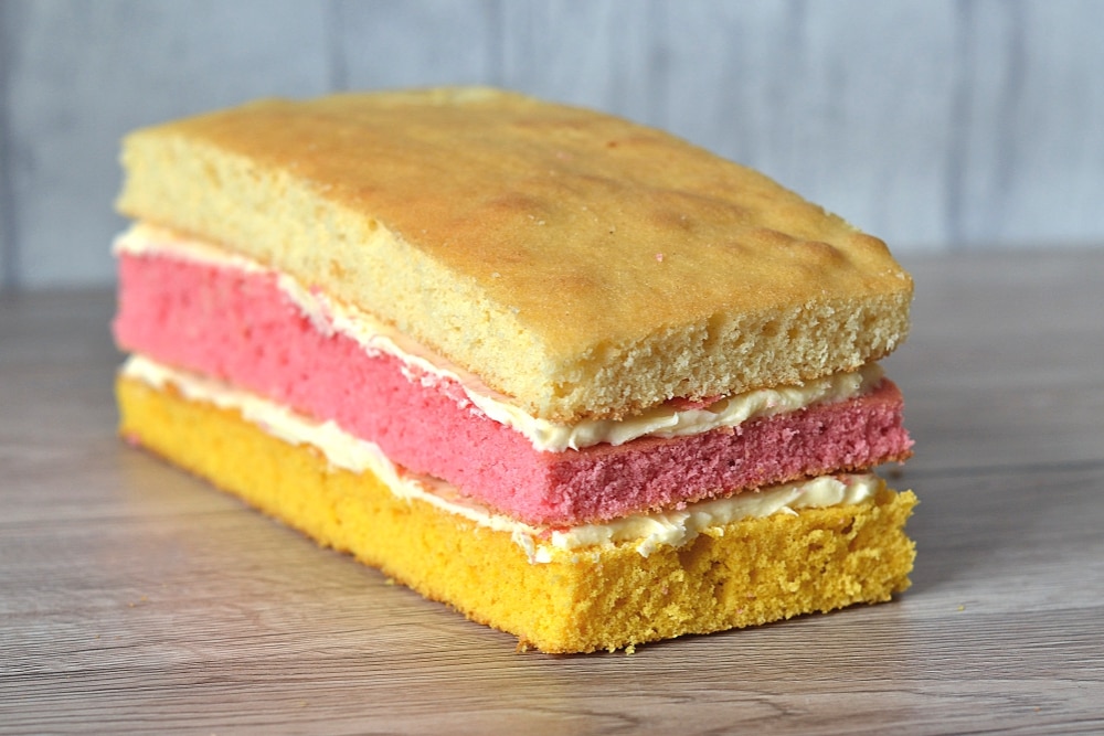 Angel Cake. The classic layer sponge loaf. Pink, yellow and plain, sandwiched together with buttercream.