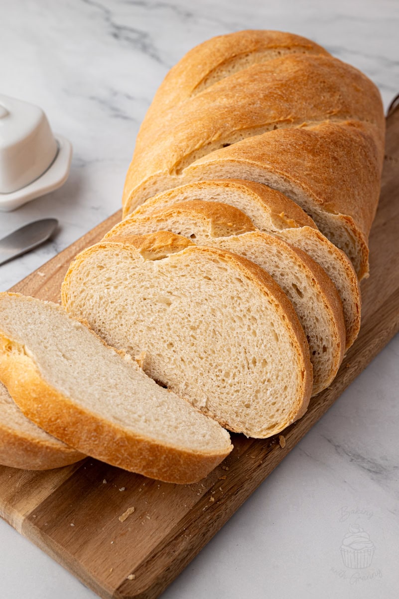 Several slices of homemade white bread cut from a fresh loaf.
