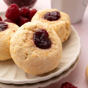Close-up of soft British rasp buns with golden tops and raspberry jam filling.