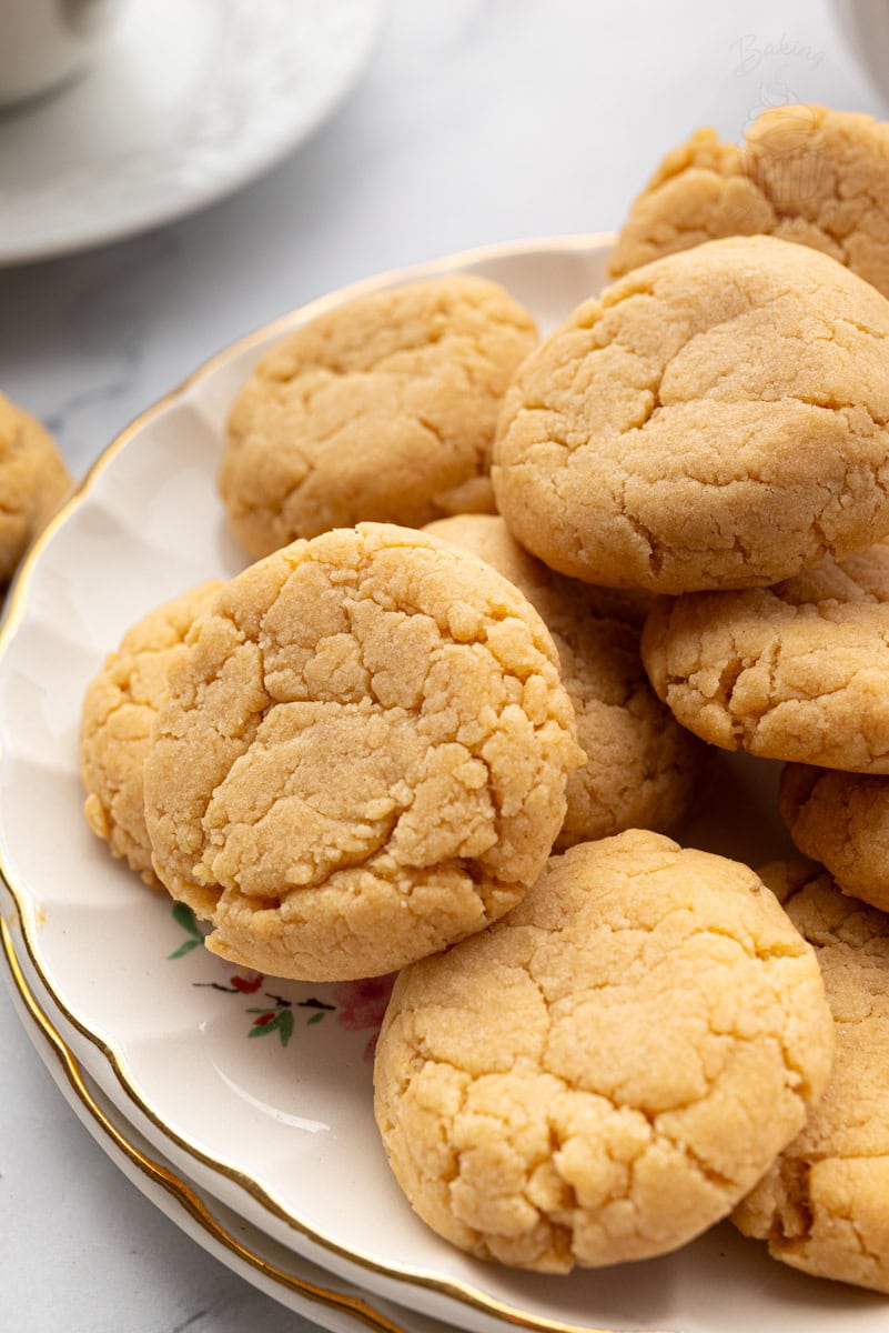 Close-up of golden gingernut biscuits showing their cracked, crunchy surface.