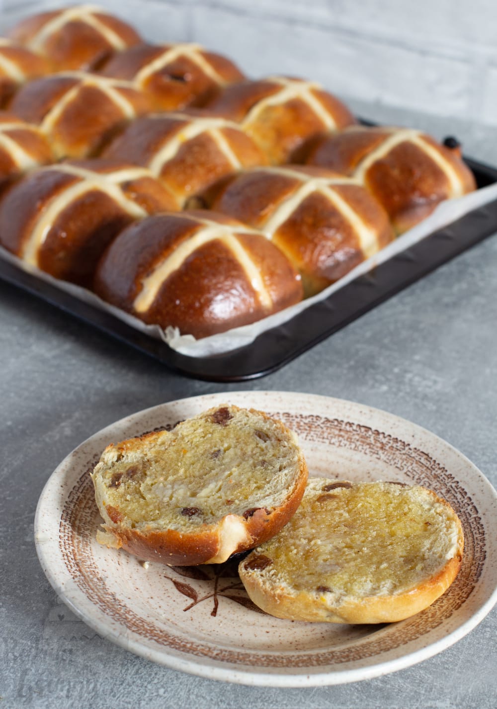 UK recipe for Hot Cross Buns. Best served toasted and with a spread of butter.