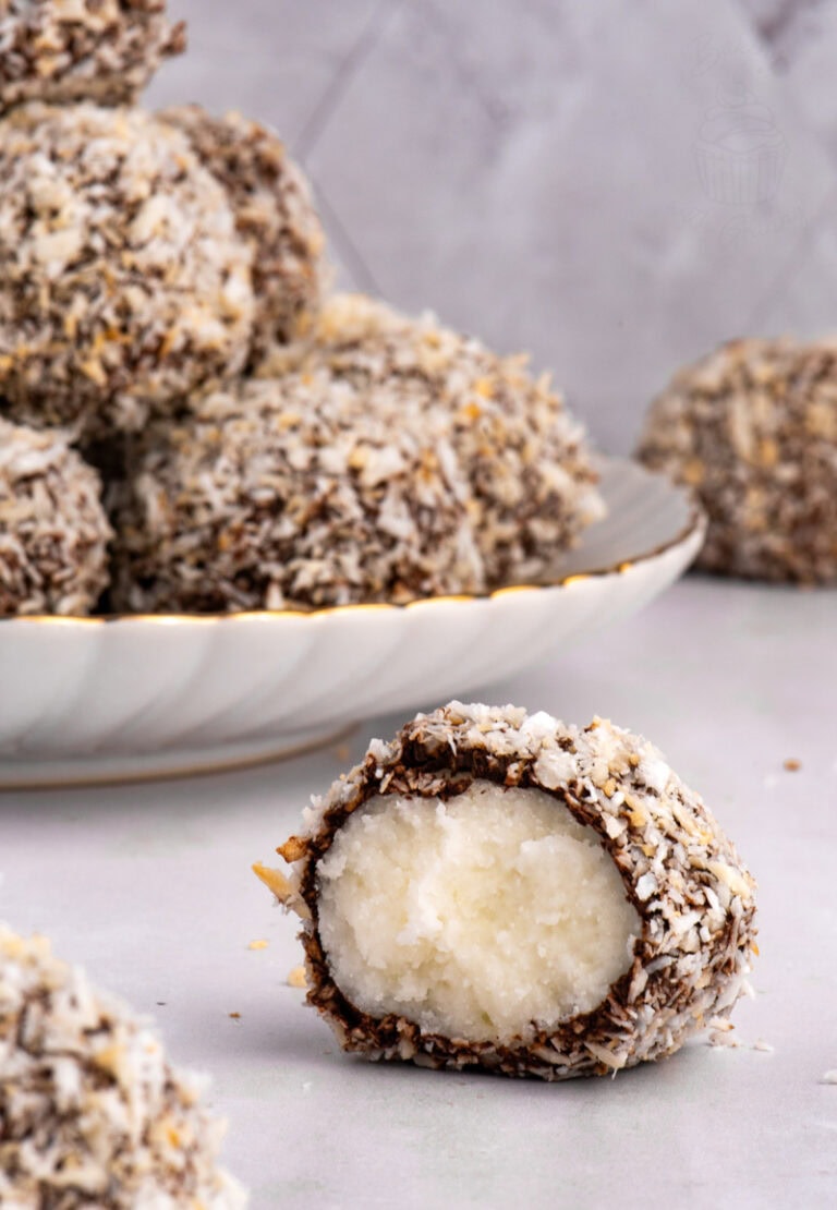 Scottish Macaroon cut in half on a plate, revealing the creamy potato fondant centre with chocolate and coconut coating.