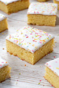School Cake recipe by Baking with Granny. Sponge cake with white icing and rainbow sprinkles.