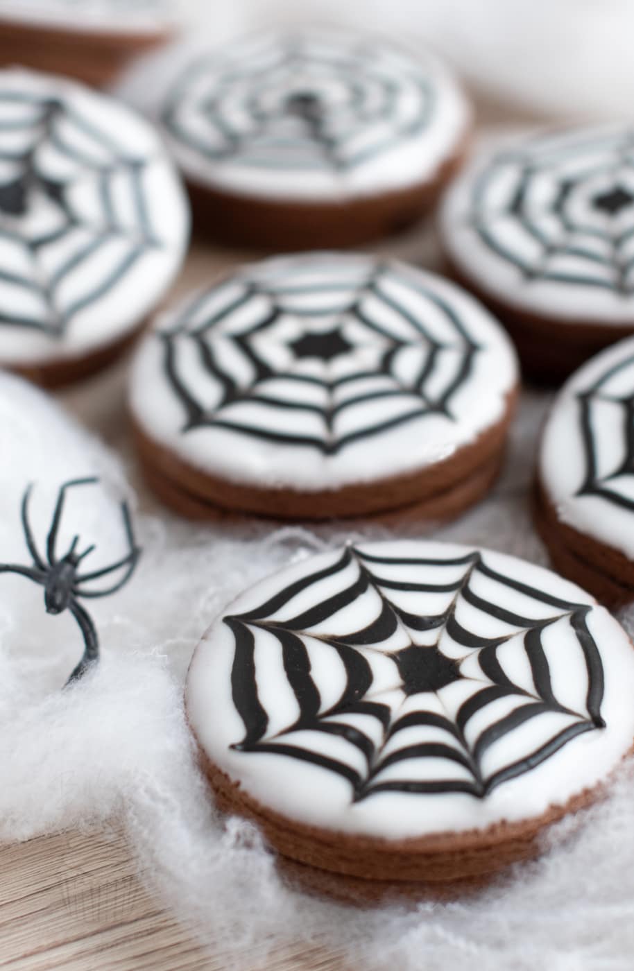 Empire biscuits decorated for Halloween, with spider web icing design.