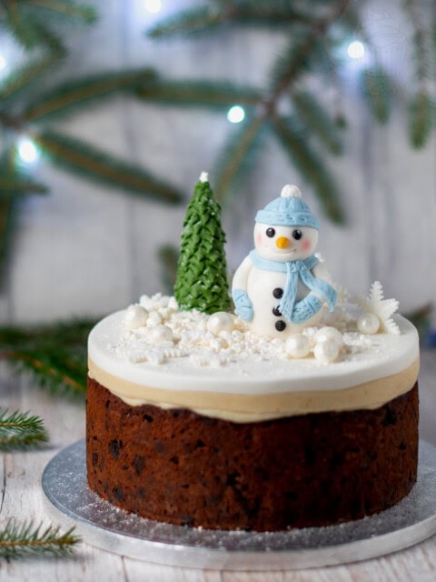 Classic Christmas Cake recipe. Rich fruit cake, topped with marzipan and fondant icing. Decorated with a fondant snowman and Christmas Tree.
