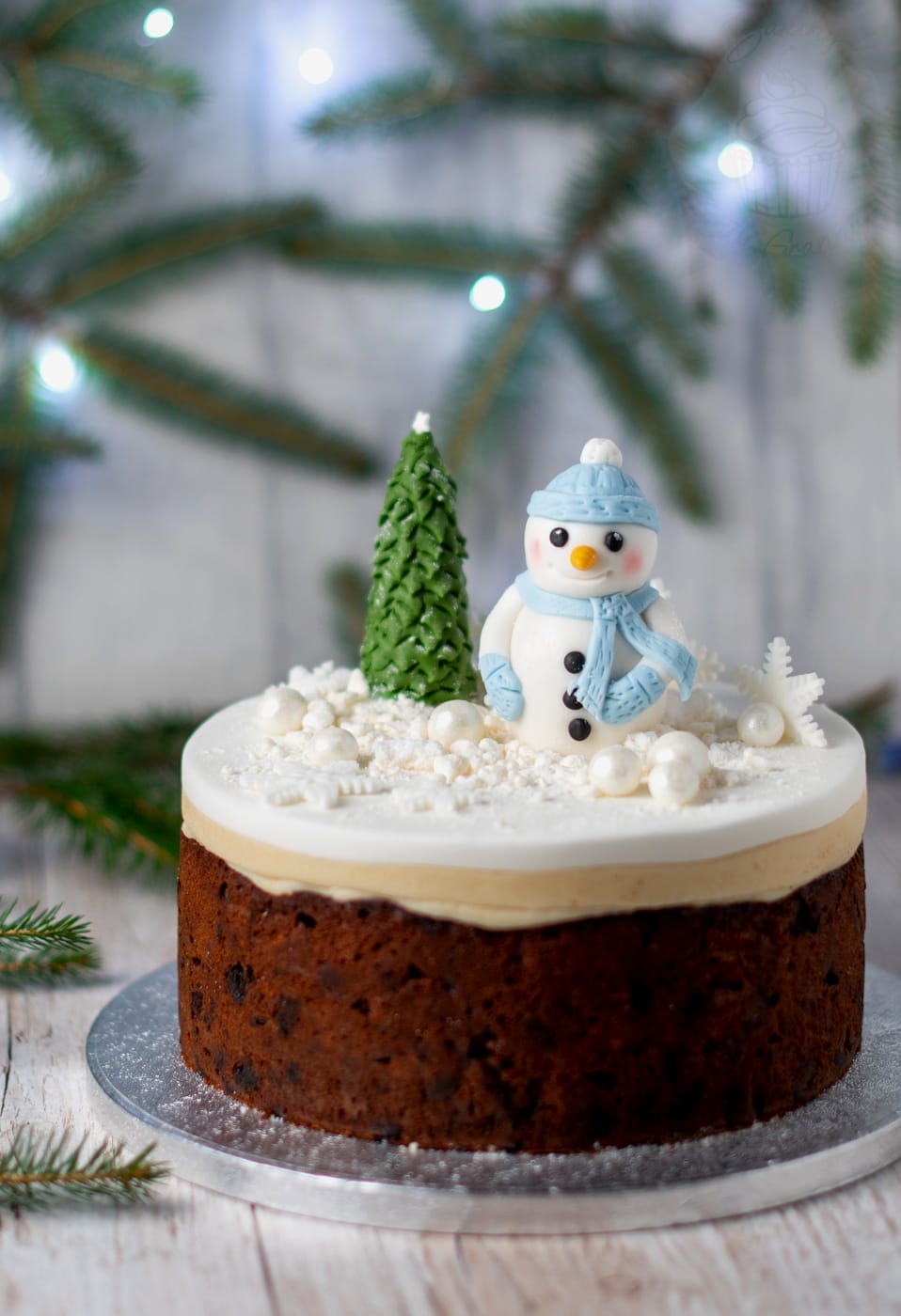 Classic Christmas Cake recipe. Rich fruit cake, topped with marzipan and fondant icing. Decorated with a fondant snowman and Christmas Tree.