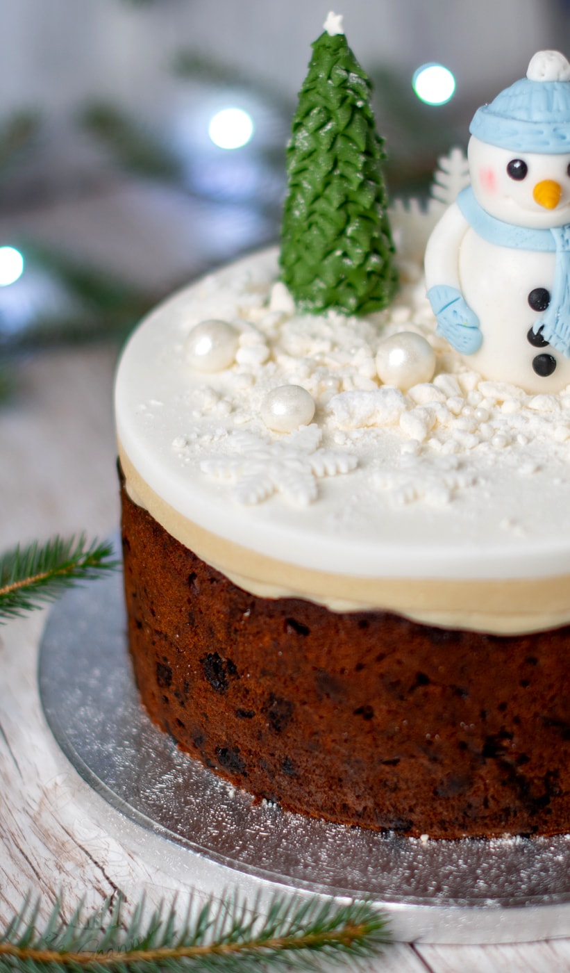 Close up of a classic fruit Christmas cake, from Baking with Granny. Topped with marzipan and white icing.