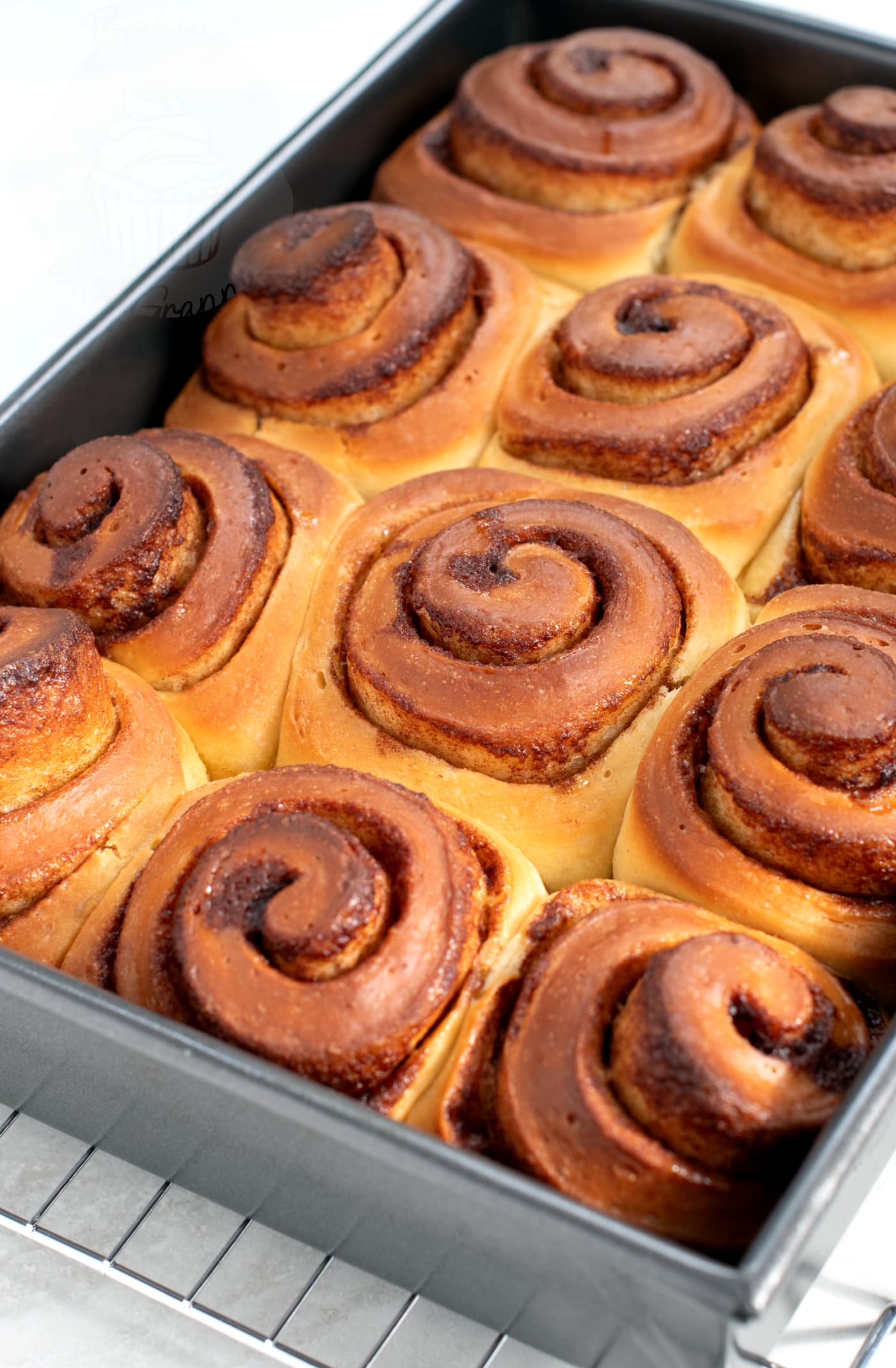 Homemade Cinnamon Buns UK Recipe from Baking with Granny. Tray of delicious buns, pre-icing.