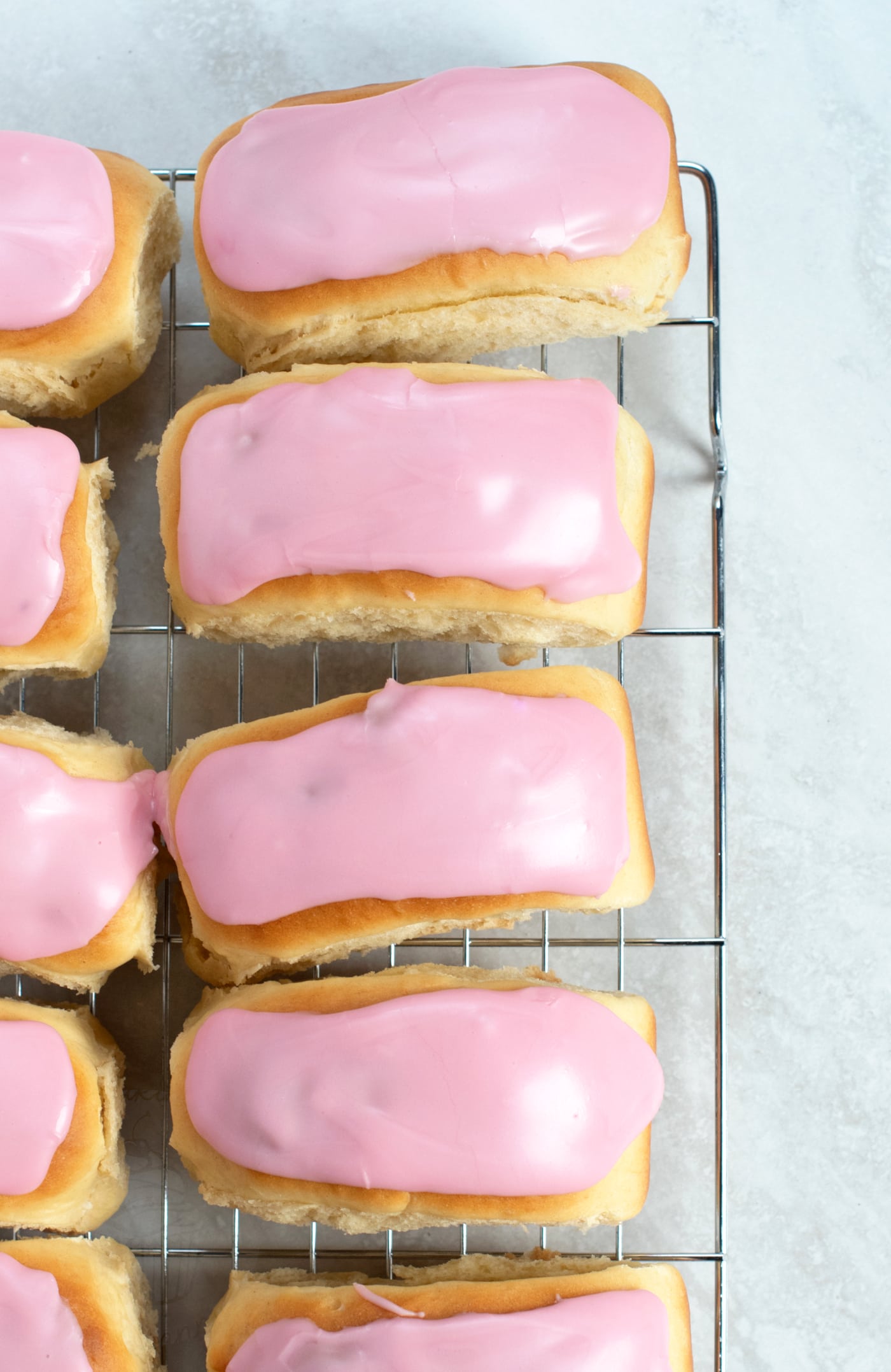 Iced Finger Buns, traditional British cake. Made with a sweet yeast dough, topped with easy water icing.