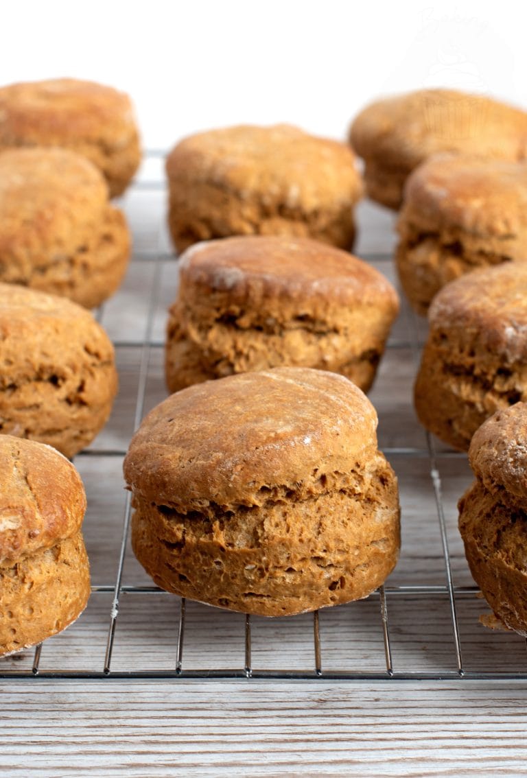 Freshly baked Scottish treacle scones cooling on a metal rack against a light background.