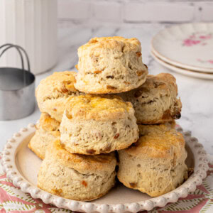 Tower of golden Fruit Scones stacked on a rustic plate, ready to serve.