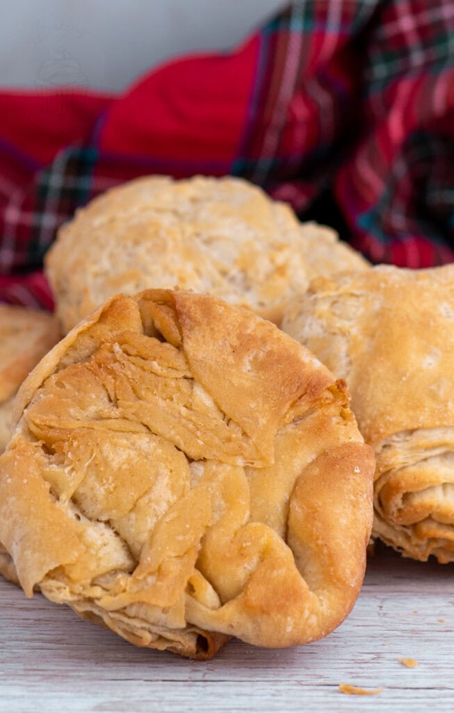 Close-up of a traditional Scottish buttery (rowie) showing flaky, golden layers.