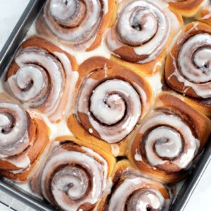 Homemade cinnamon buns with soft swirls and sweet icing.
