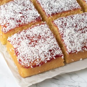 Jam and coconut school cake topped with raspberry jam and desiccated coconut.