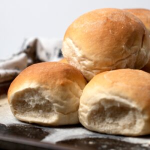 Freshly baked Scottish morning rolls with golden, lightly floured crusts.