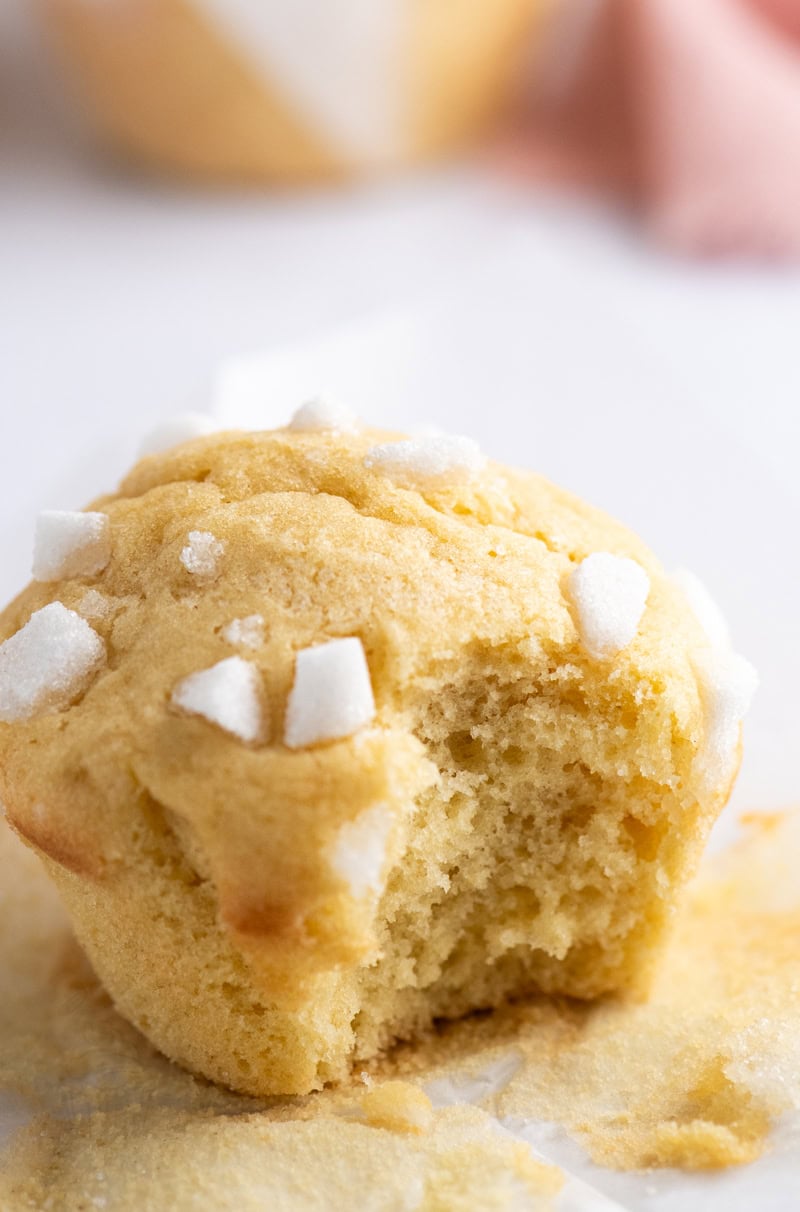 Close-up of a Sair Heidie sponge cake with a bite taken out, showing the soft fluffy texture and sugar cube topping.