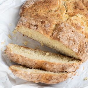 Sliced Irish soda bread showing its soft crumb and golden crust.
