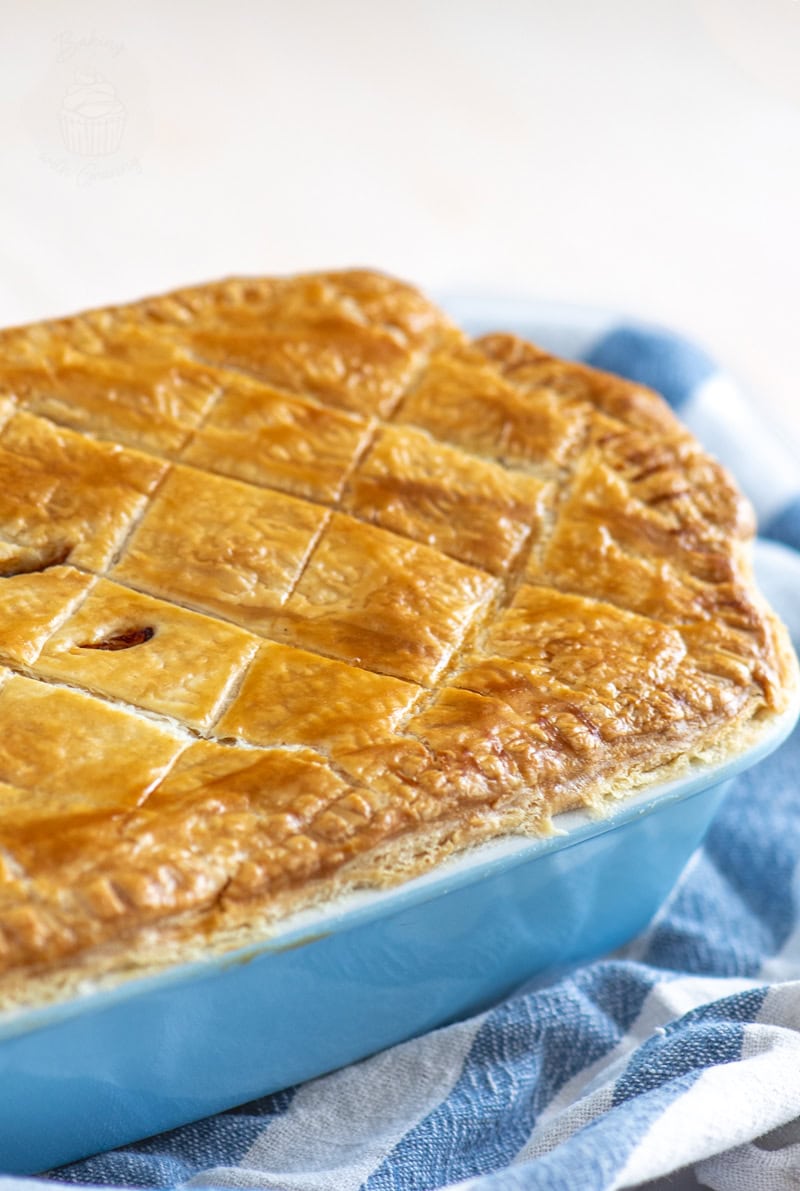 Whole homemade Scottish steak pie with puff pastry topping, baked golden and ready to serve.