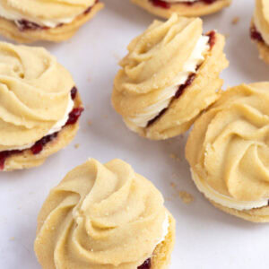 Selection of homemade Viennese Whirls biscuits with piped butter biscuit swirls sandwiched with jam and buttercream.