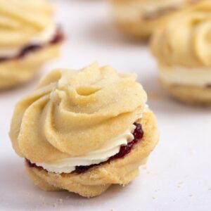 Viennese Whirl with piped buttery biscuits, jam and buttercream filling.