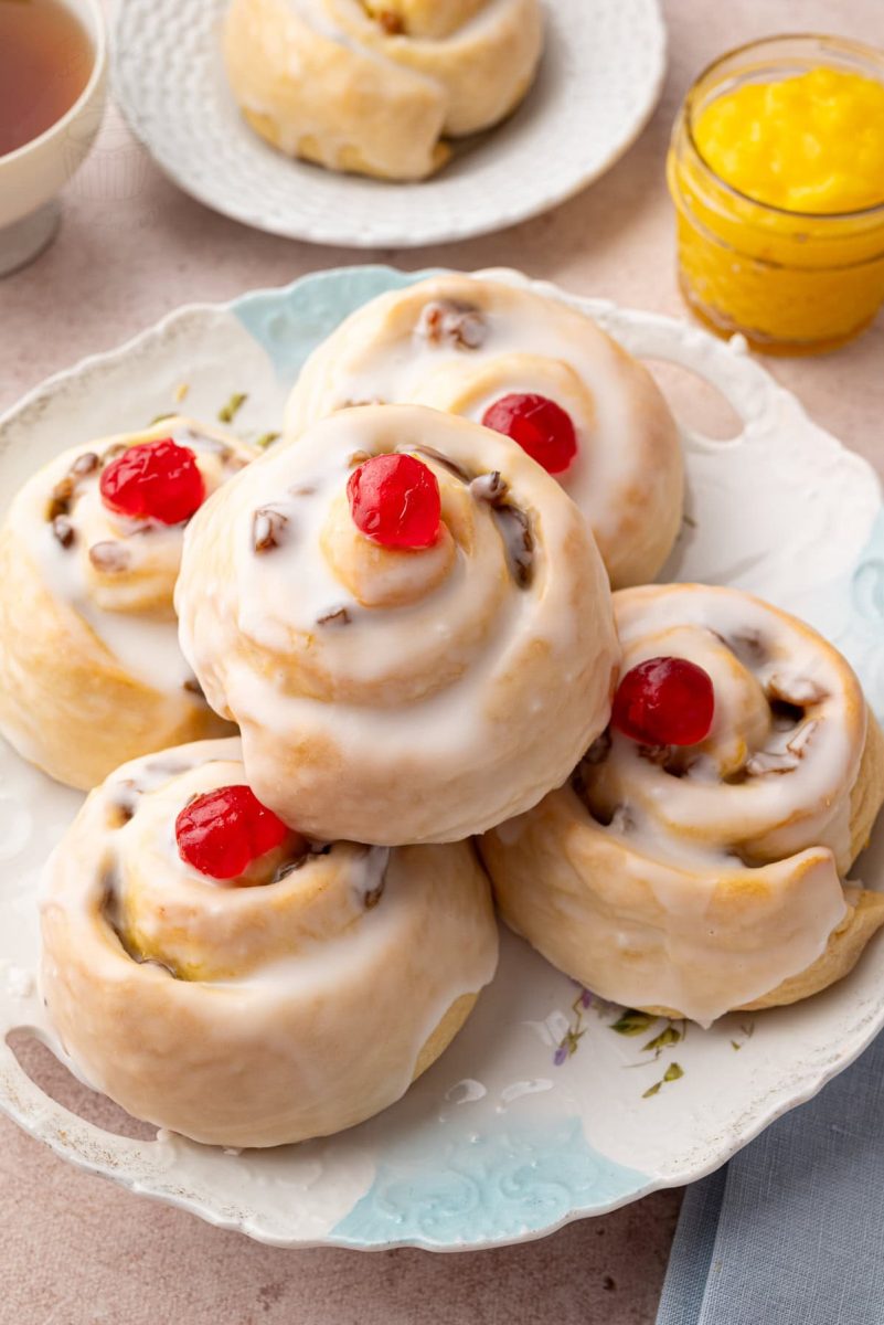 Belgian Buns Selection of Belgian buns on a plate, surrounded by a cup of tea and a jar of yellow lemon curd.