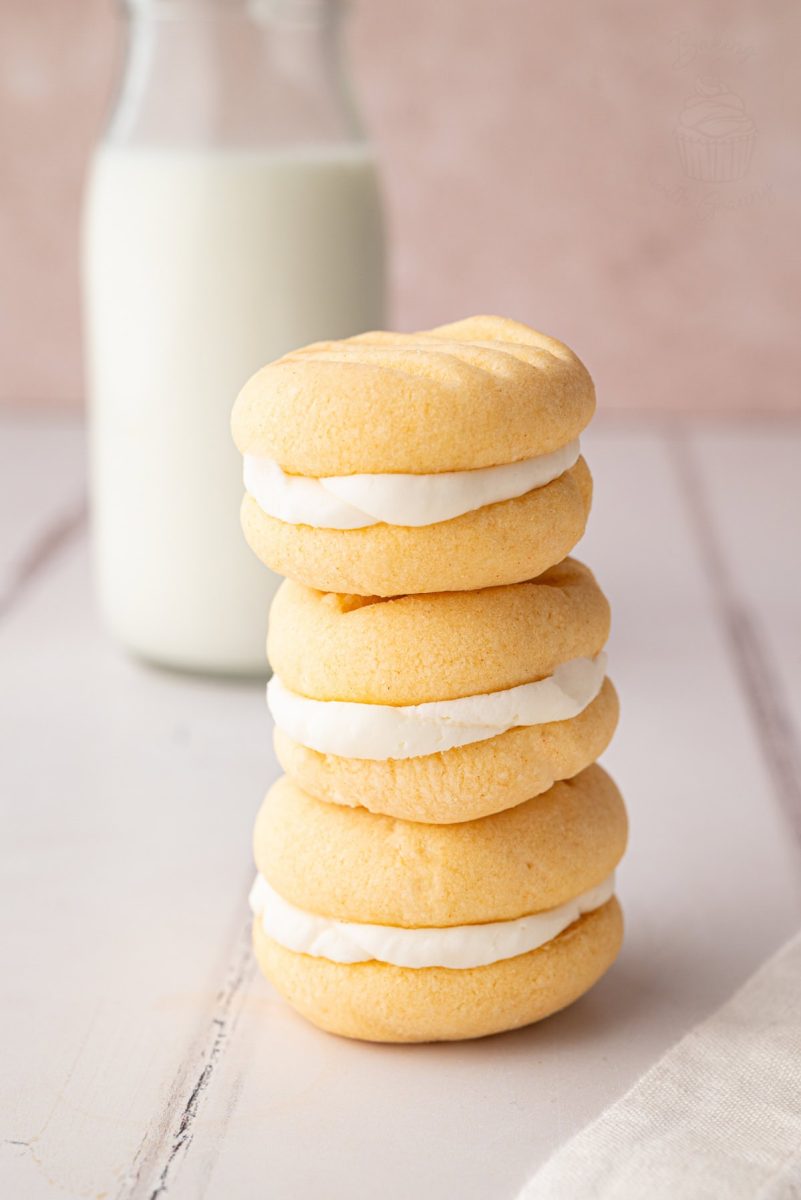 Custard Creams Stack of four custard cream biscuits with bottle of milk in the background.