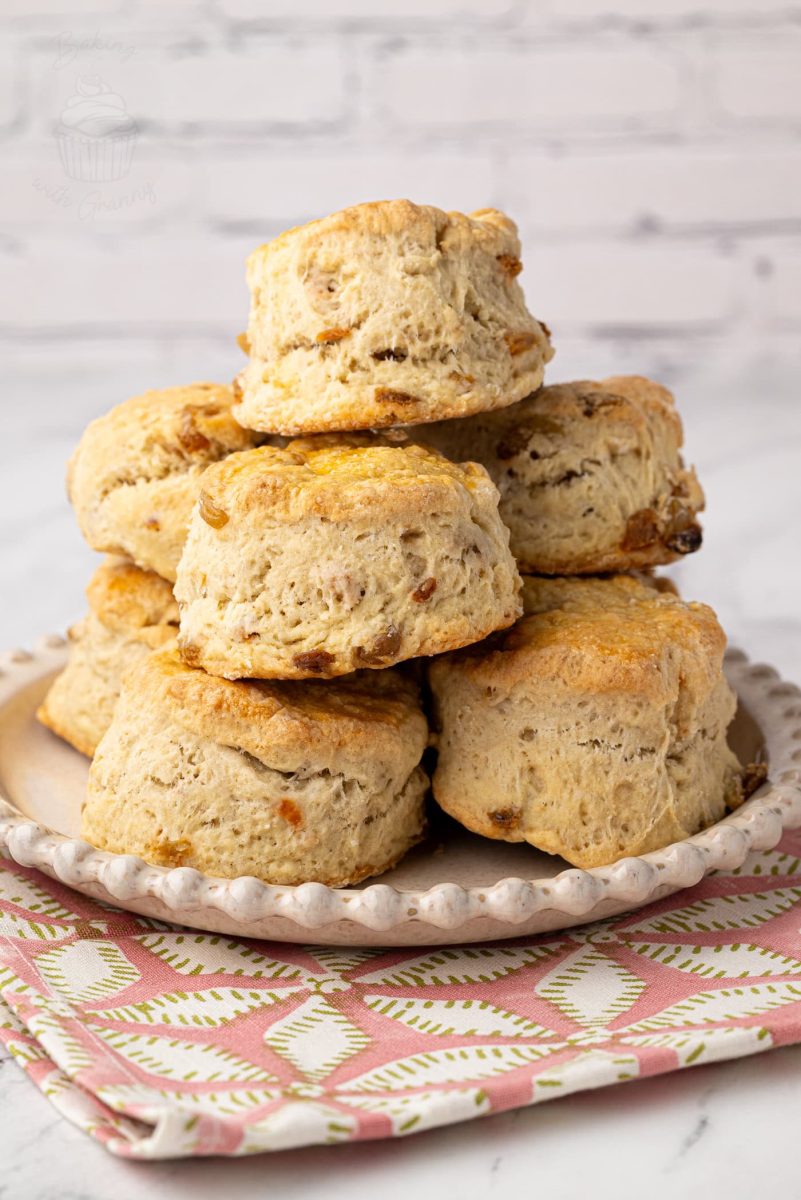Fruit Scones Freshly baked home made Fruit Scones on a white plate, perfect for a traditional afternoon tea.